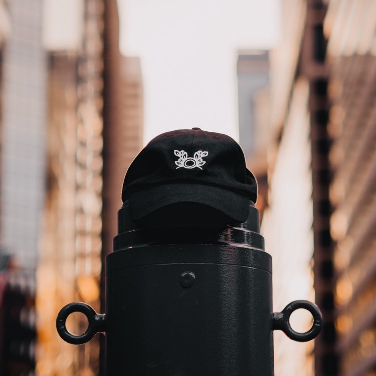 Black Bean2Bean dad hat with white embroidered logo on front, shot outdoors in Philly