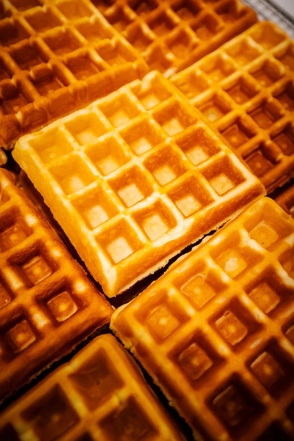 Close-up of golden brown waffles with a grid pattern.