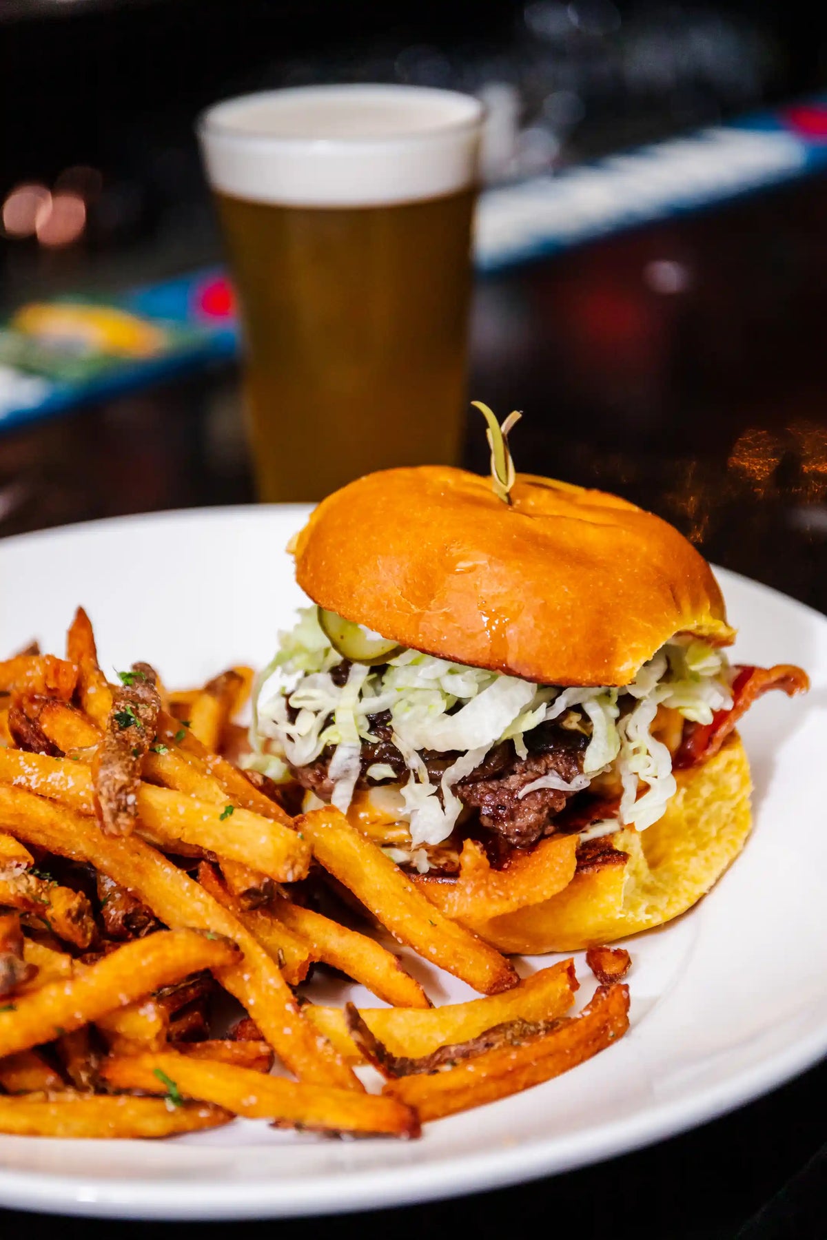 Burger with fries and a beer on a plate