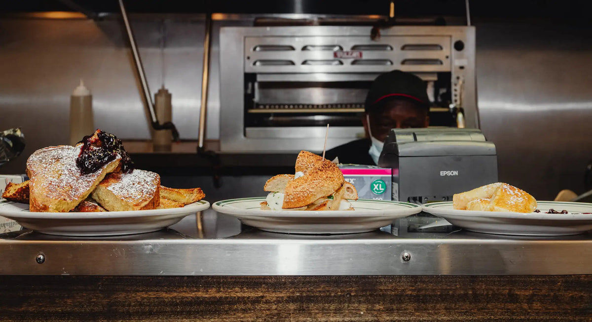 Dishes of food on a counter with a printer in the background