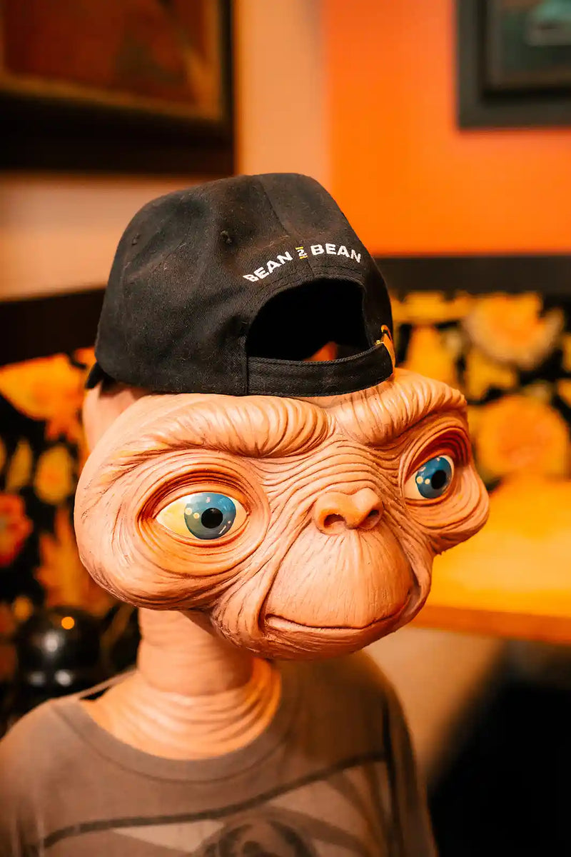 ET life size figurine wearing a black Bean2Bean baseball hat at Buzz Cafe