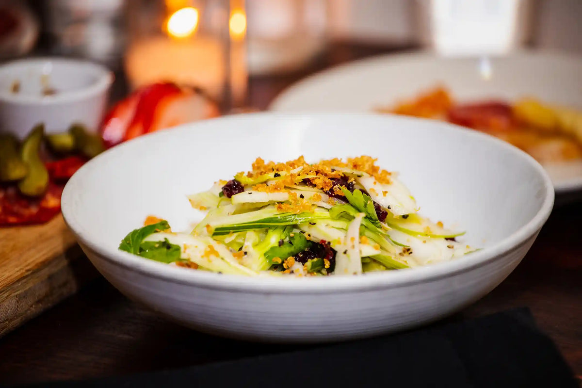 Bowl of salad with vegetables on a wooden table