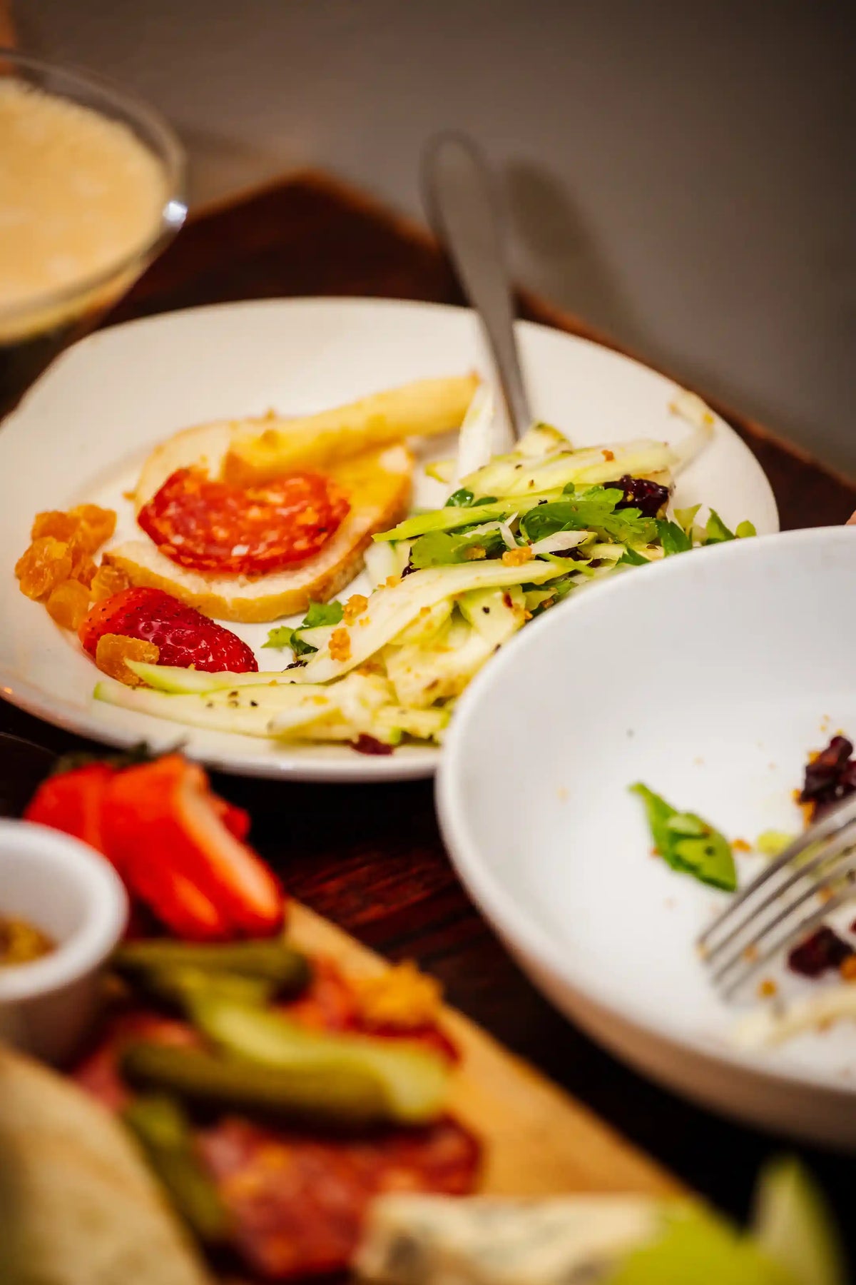 Plated dish with salad and bread on a wooden table