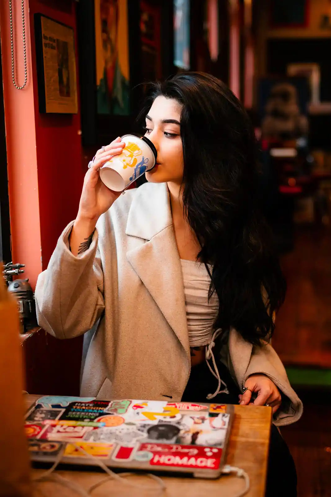 Woman drinking from a coffee cup in a cozy indoor setting