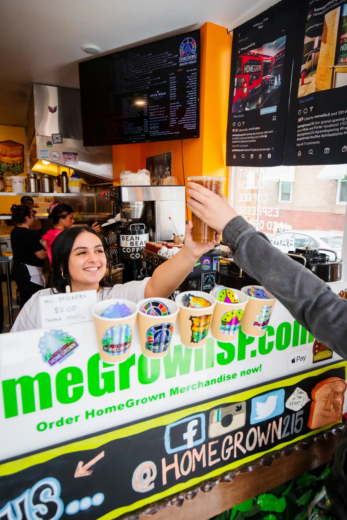 Person ordering at a coffee shop with a focus on HomeGrown branding.