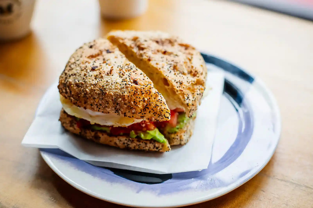 Bagel sandwich on a plate with a blurred background