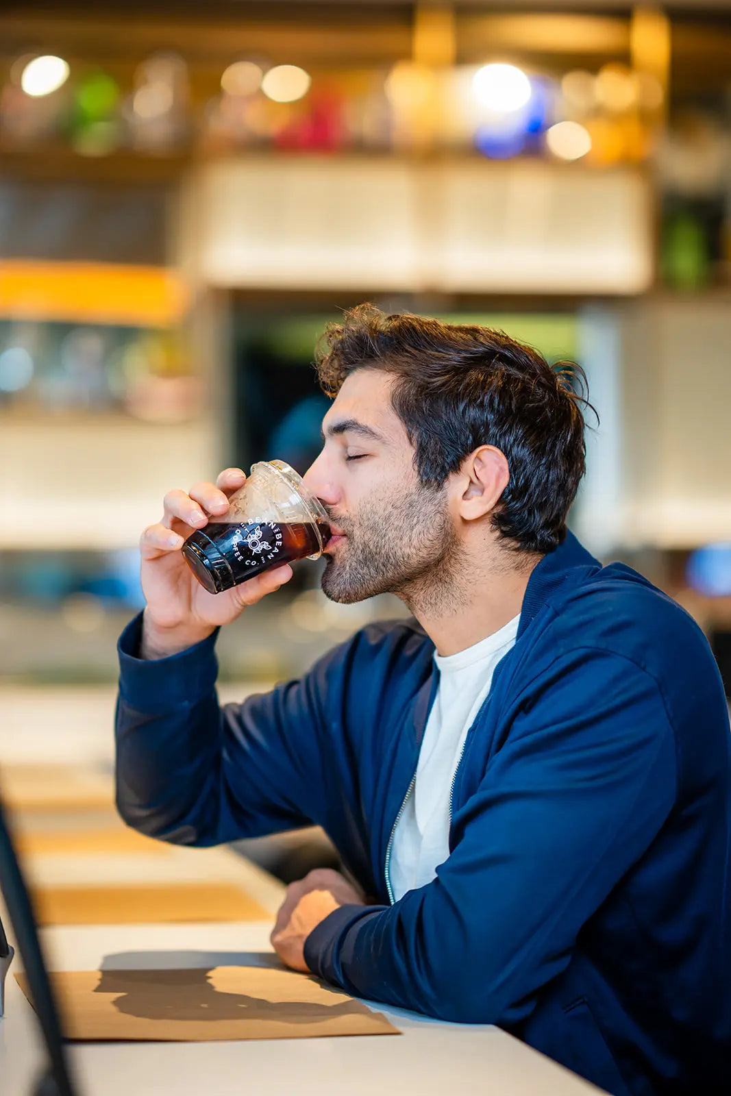 Man drinking his Bean2Bean Cold Brew at PHL airport