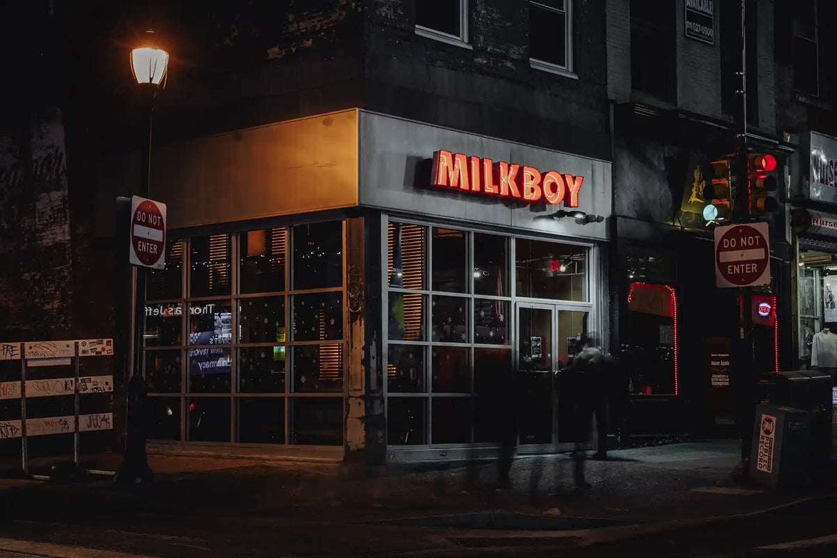 MilkBoy Chestnut St. Philadelphia store front at night with illuminated sign