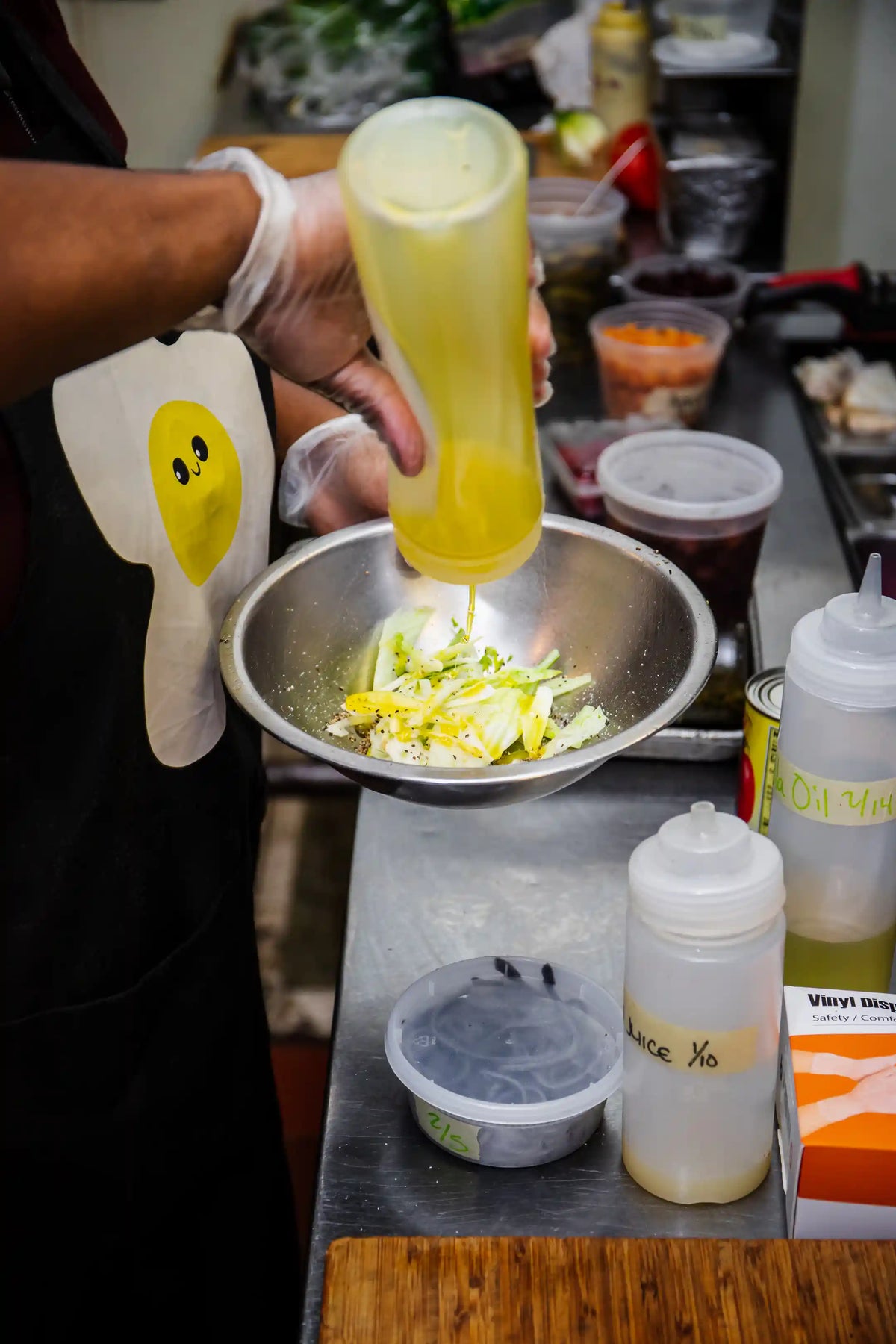 Person preparing food in a kitchen with various ingredients and utensils.