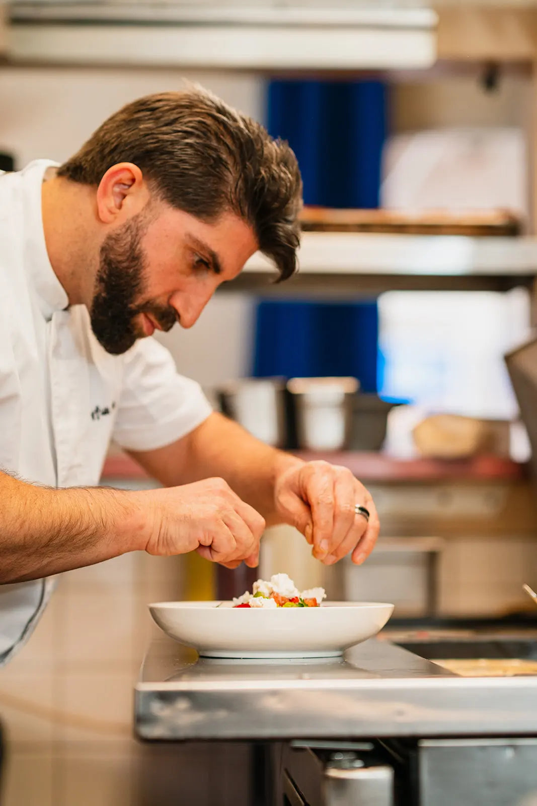 Chef preparing a dish in a kitchen at Kanella Grill