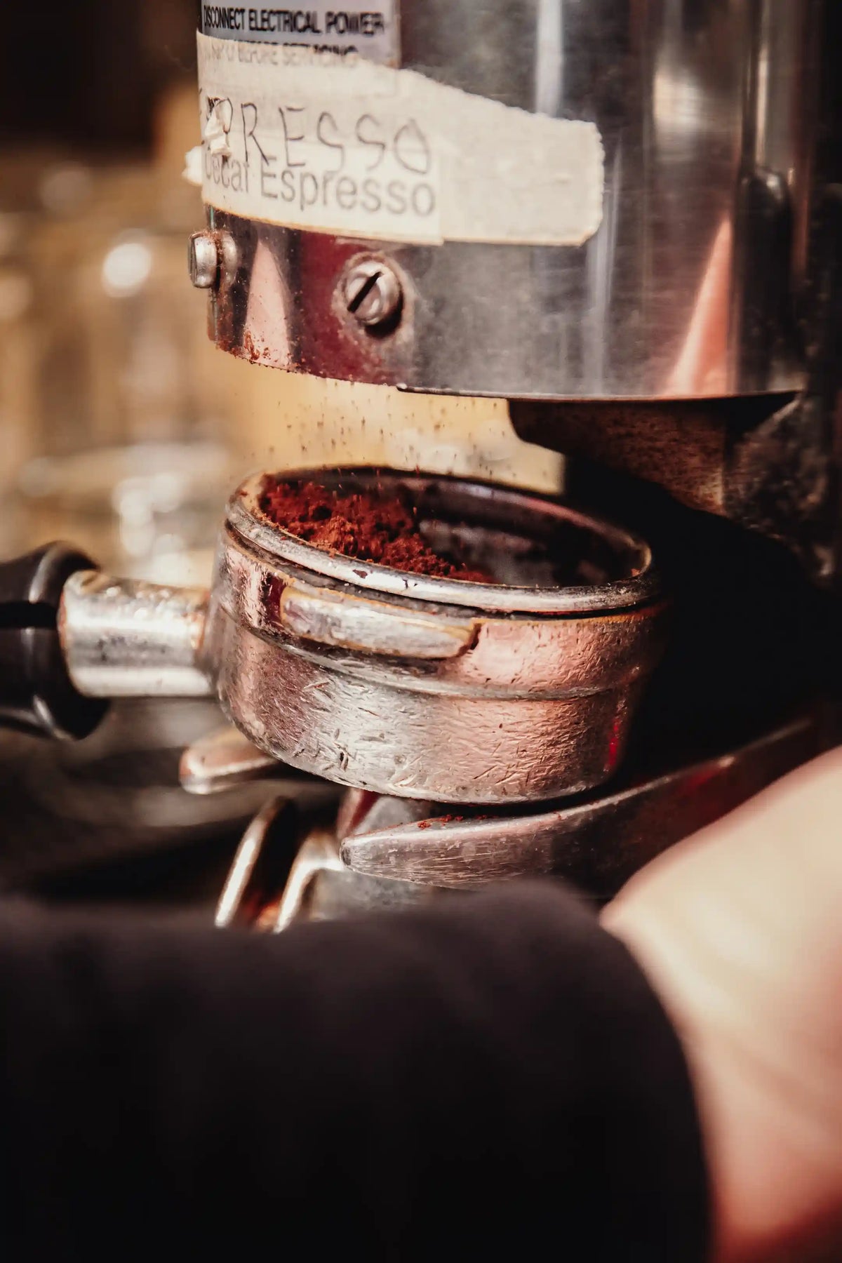 Close-up of an espresso machine with ground coffee
