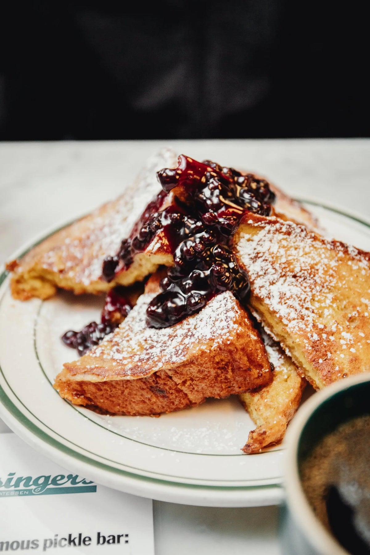 French toast with berry sauce on white plate