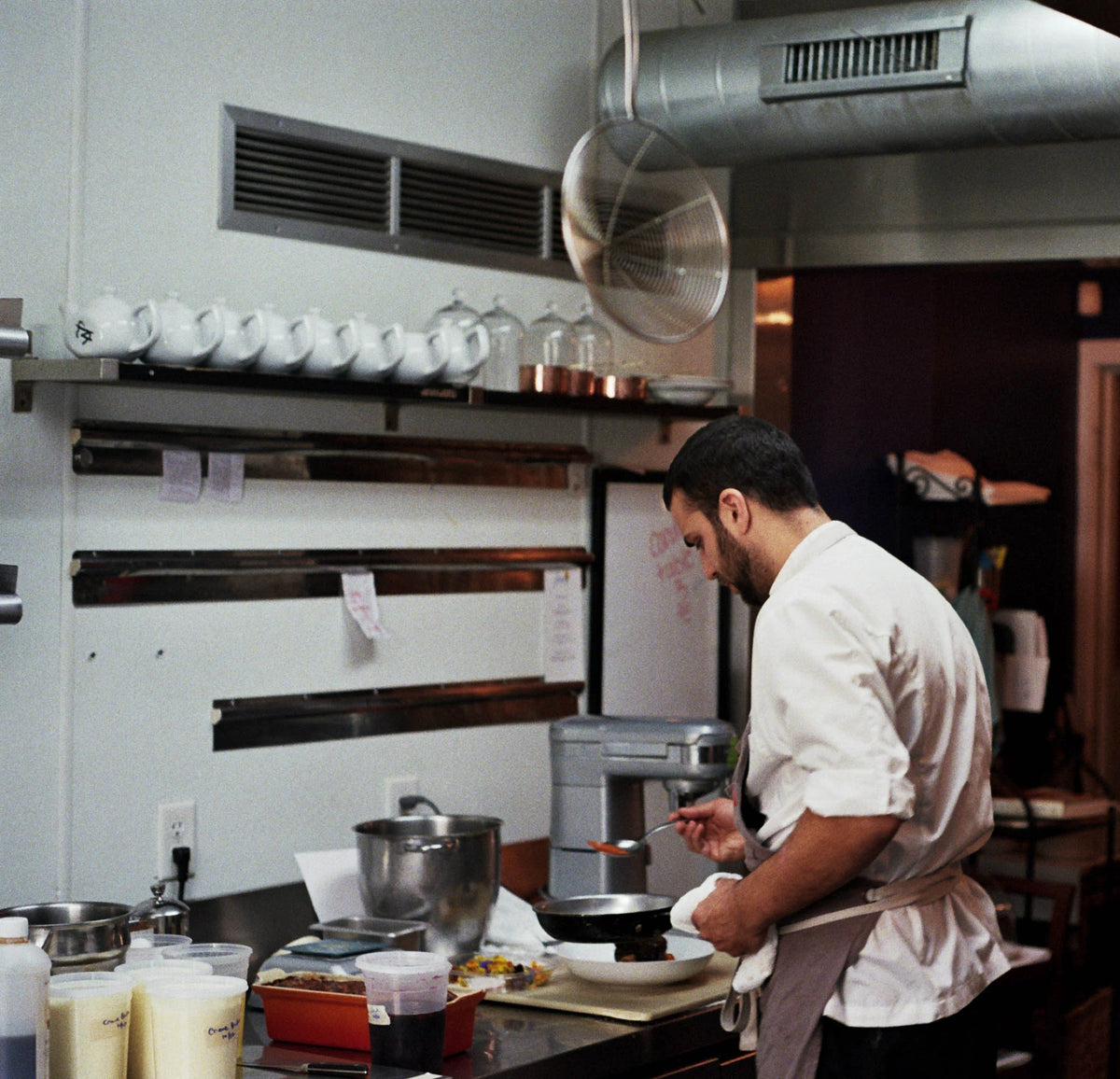 Chef Richard Cusack preparing food in a professional kitchen