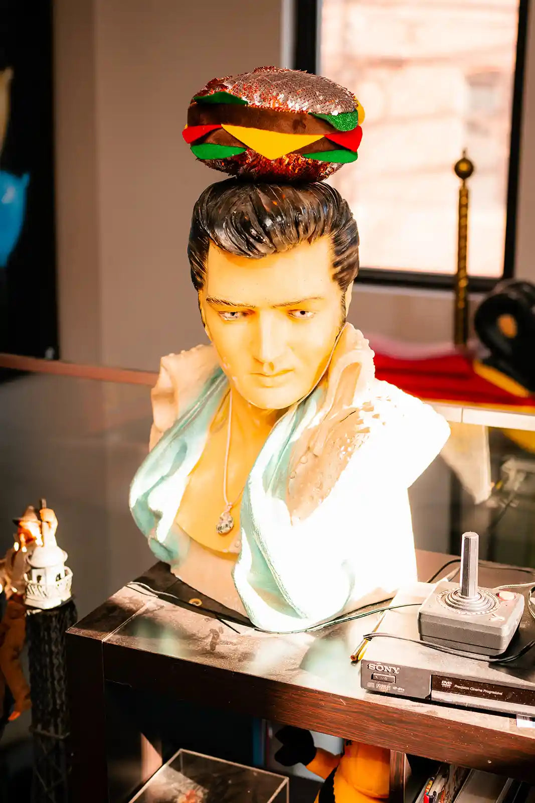 Elvis Presley bust with sandwich stuffie on his head