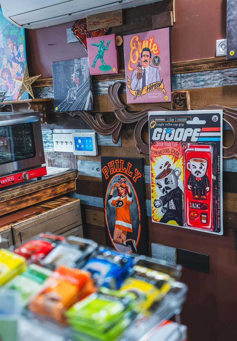 Vintage toy display with action figures and packaging on a wooden shelf.