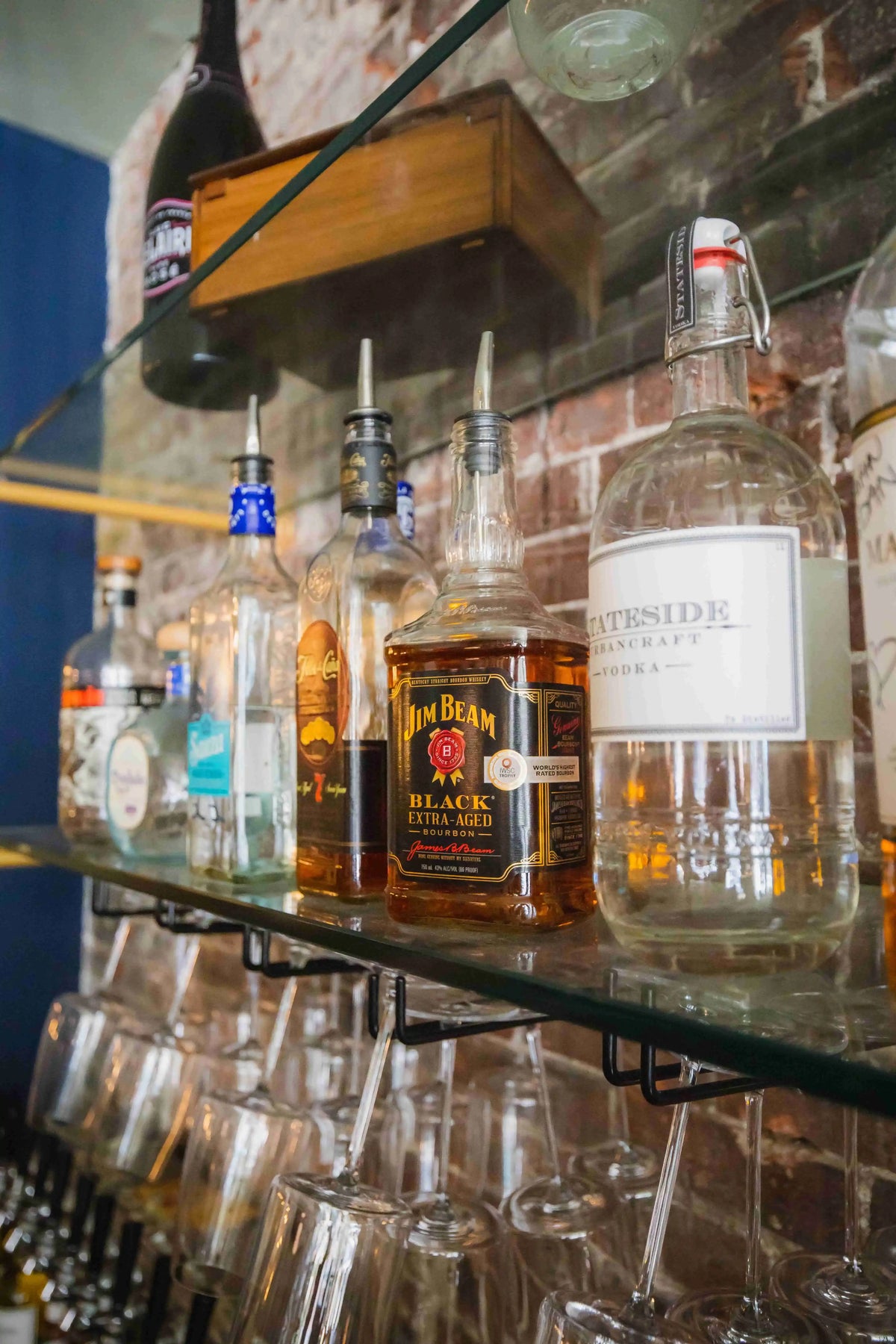 Bar shelf with liquors including a bottle of jim beam