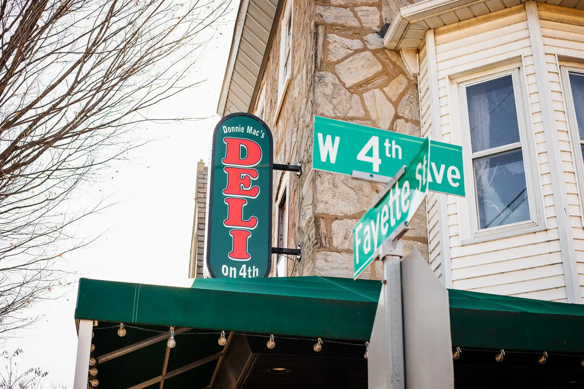 Del on 4th corner sign with cross stree signs "4TH" and "fayette St."
