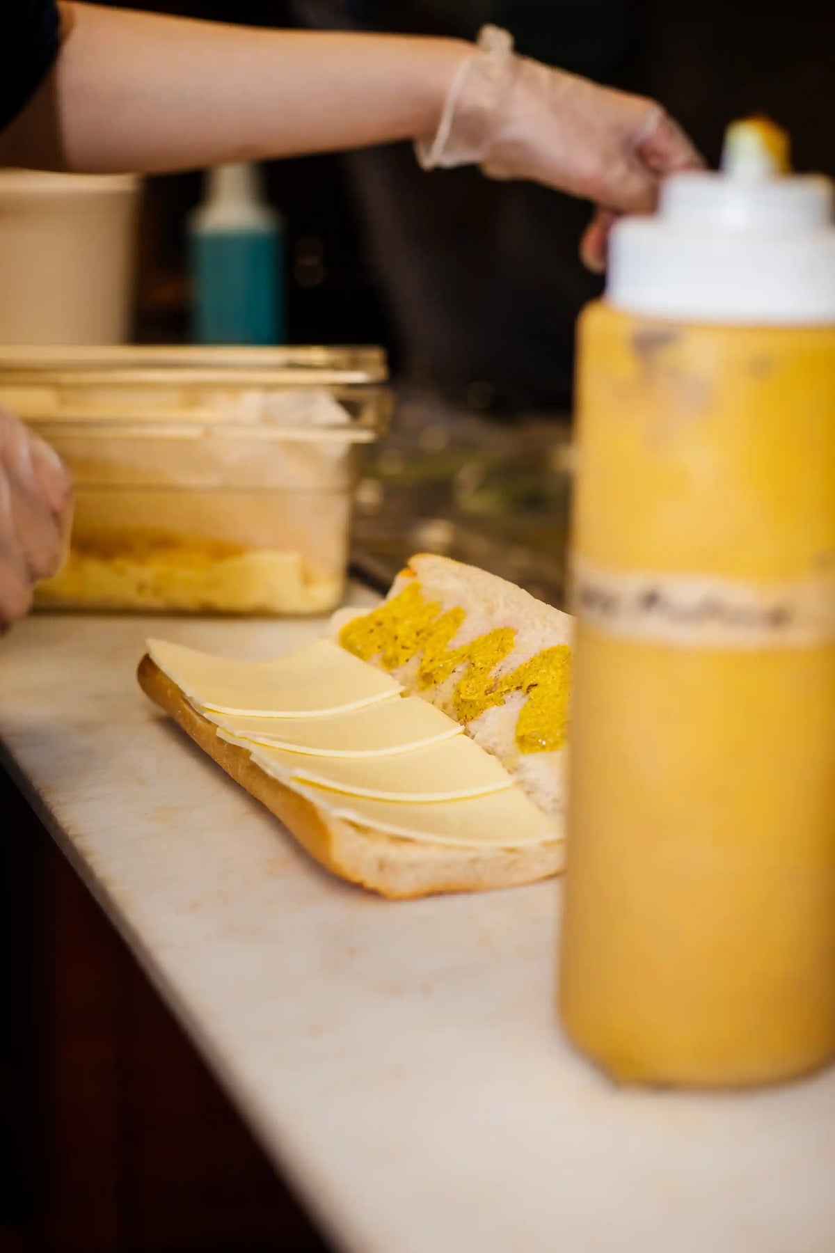 still-open hoagie sandwich being assembled in a prep area of a kitchen