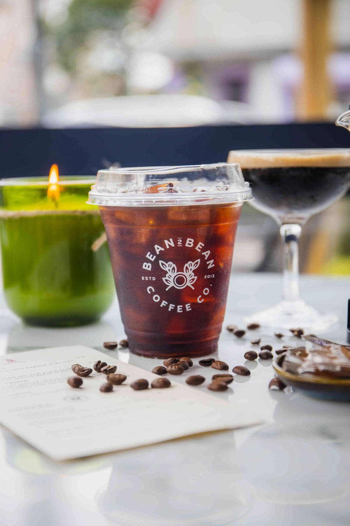 Bean2Bean Cold Brew in plastic to-go cup with logo in white on cup