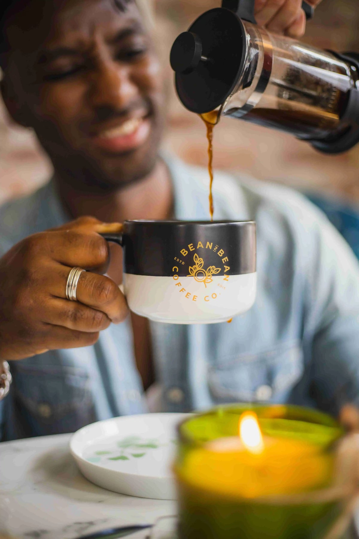 coffee being poured from a french-press into Bean2Bean ceramic mug