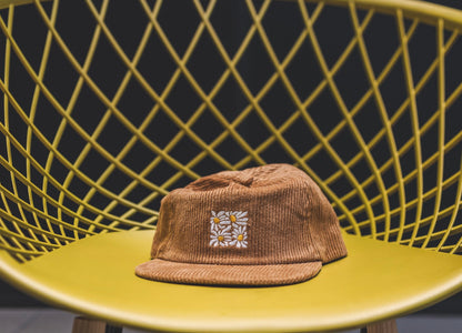 High quality flat-brimmed corduroy hat with embroidered flower design by our designer Hannah Kneisley.