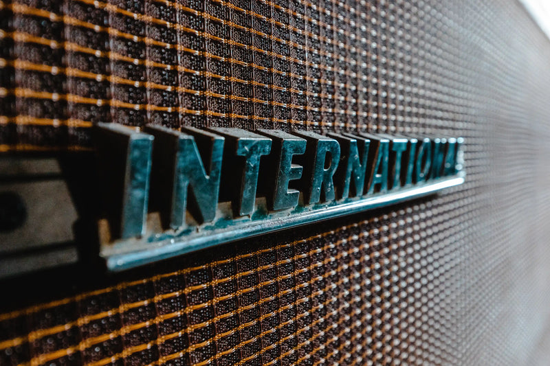 Close-up of a 'INTERNATIONAL' logo on an amplifier