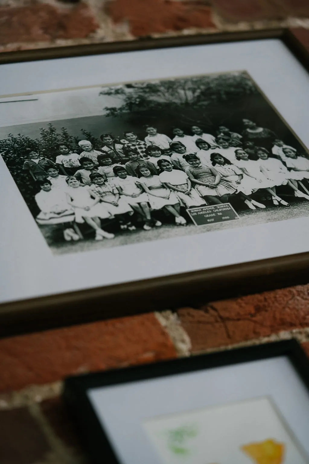 Framed black and white photo of a group of people on a brick surface