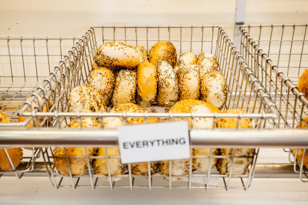 Basket of bagels with various toppings in a store setting