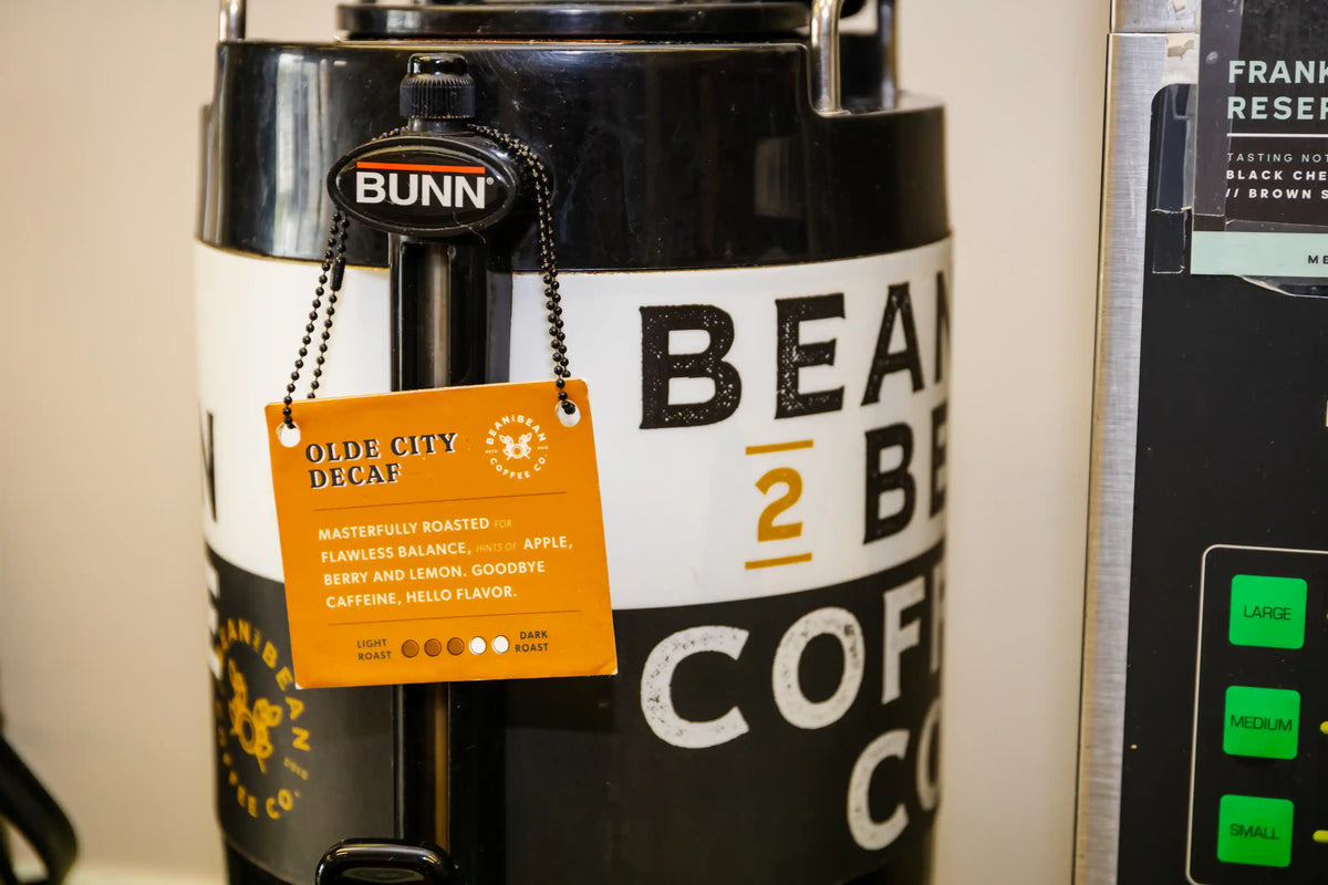 Bunn coffee maker with a label on a beige background