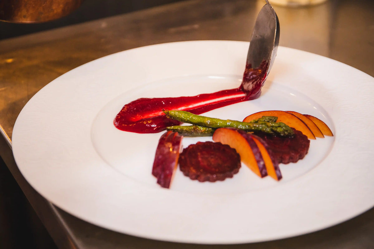 Gourmet dish with roasted vegetables on a white plate
